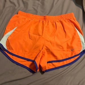 3 small Nike athletic shorts and one yellow adidas shorts, workout clothes